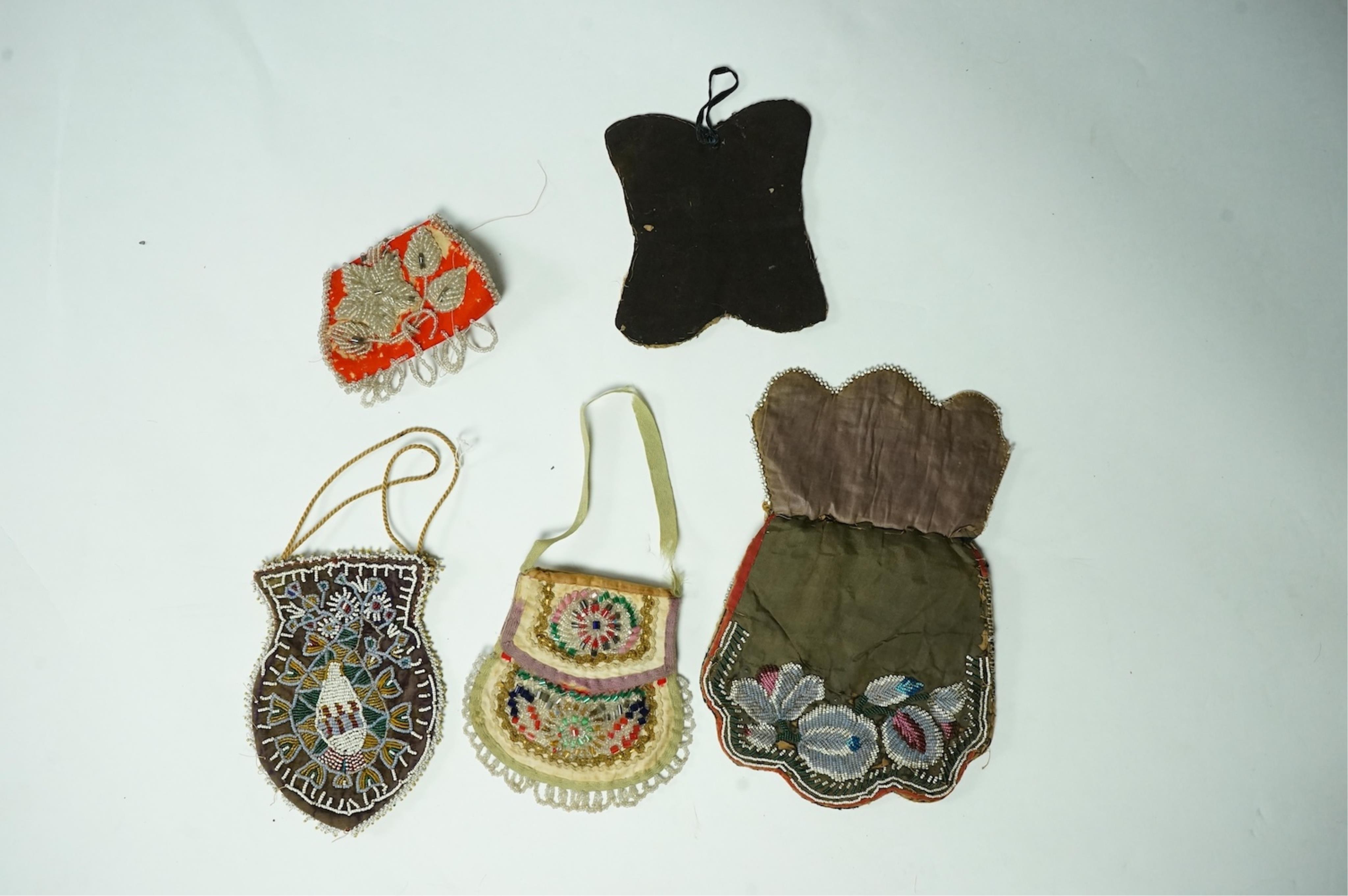 Five 19th century Native American beaded bags. Including a red felt coin pouch, three varying sized bags and a beaded panel.(5) Condition - four have damage to the fringing and beading and backing cloth. The light bag th